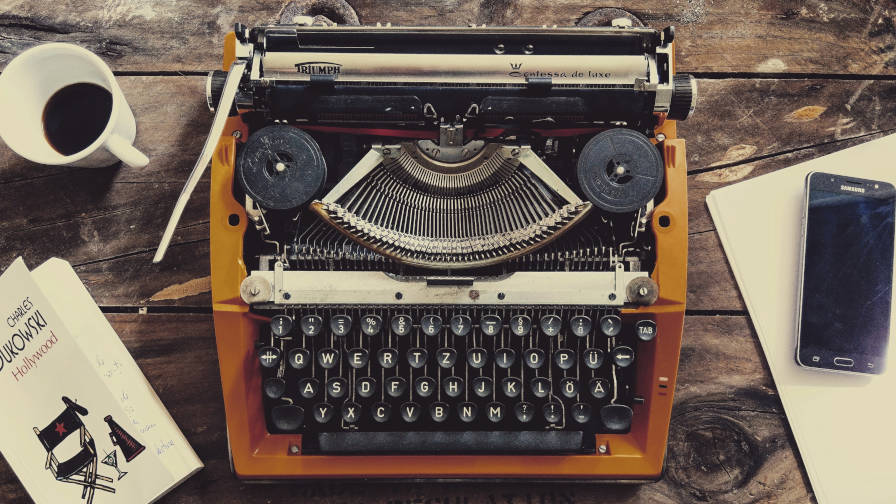 Brown typewriter on desk.