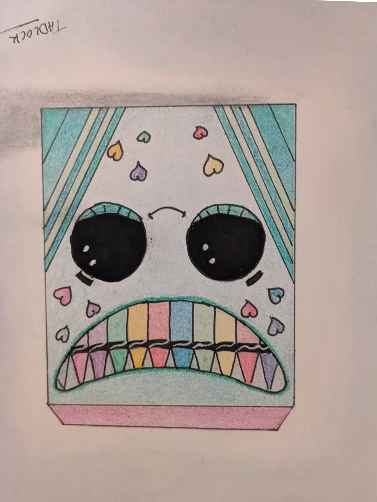 Upside down hand-drawn color crayon box with a face and hearts on the design. Fully colored.