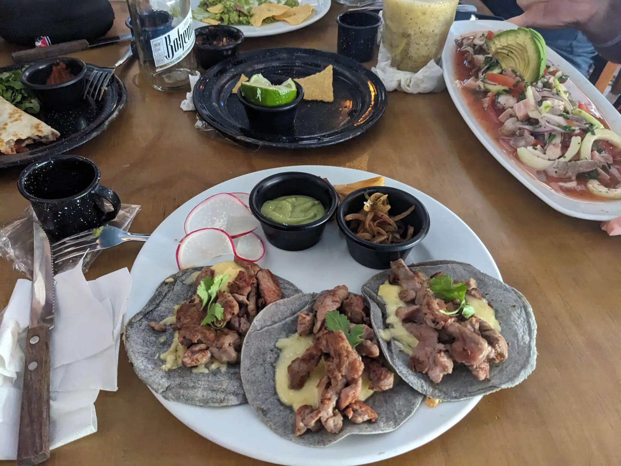 Flank steak tacos on gray/purple tortillas.