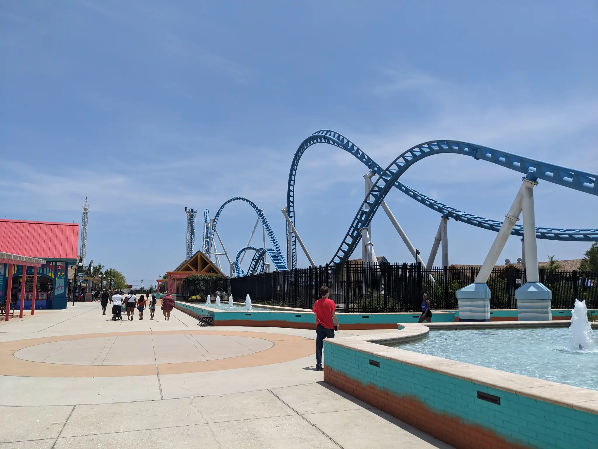 View of a long blue roller coaster.